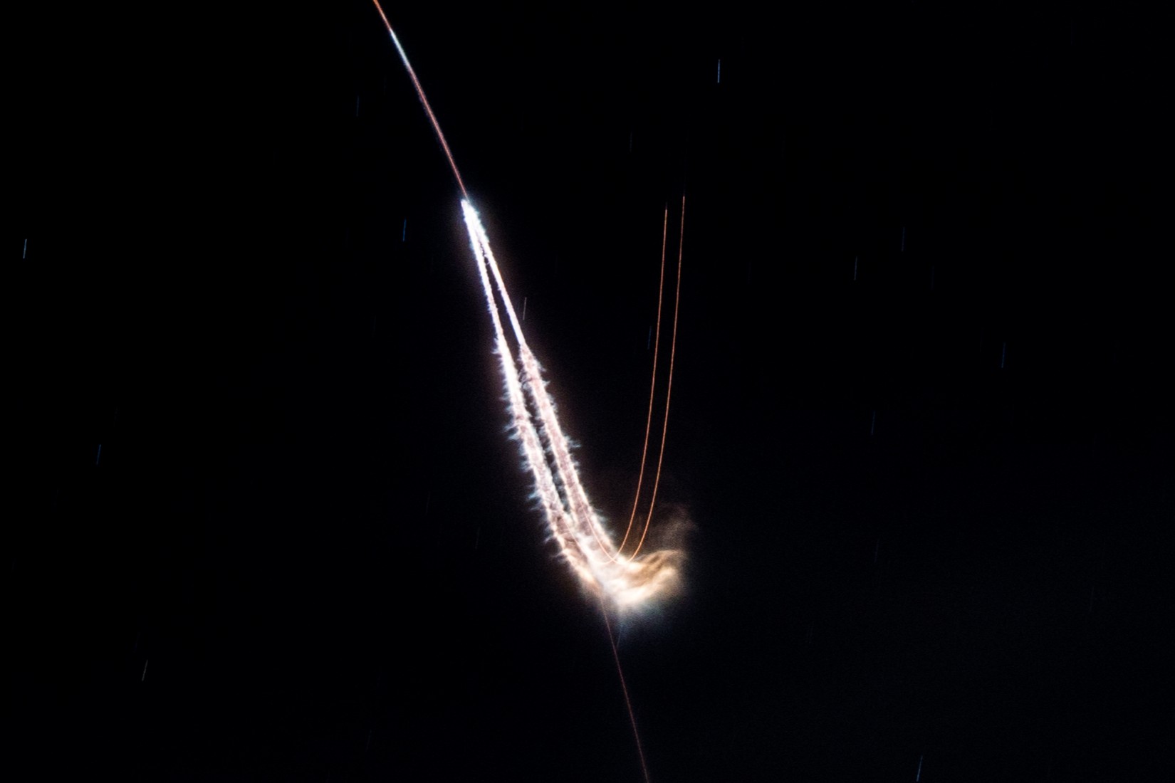 Long exposure photo of the Falcon Heavy Side Boosters during the boost back burn. Photo Credit: Eric Pearce, Florida Spaceflight