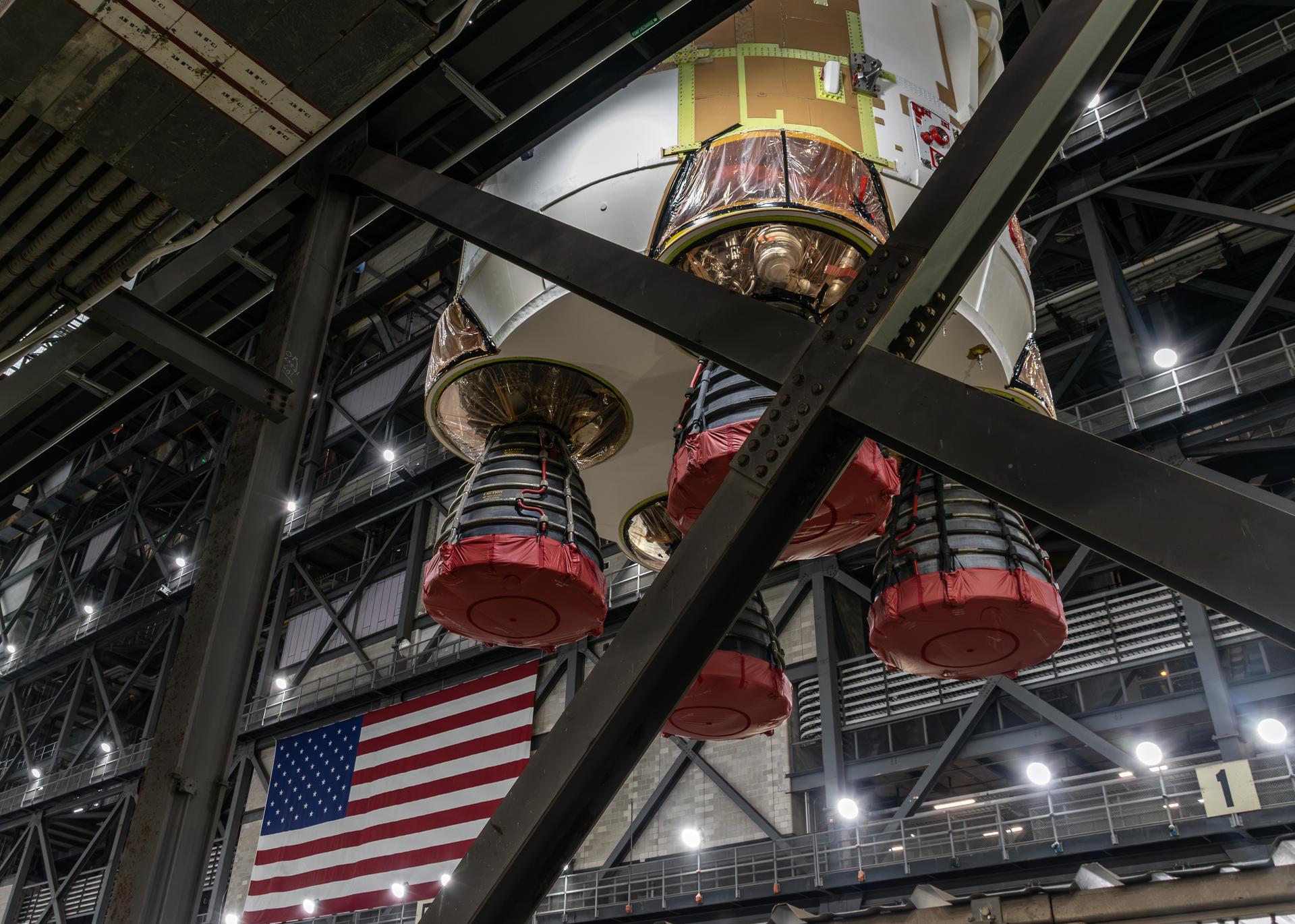 The SLS (Space Launch System) core stage is lifted from the transfer aisle of the Vehicle Assembly Building at NASA's Kennedy Space Center in Florida on Thursday, Oct 22, 2026. Photo Credit: NASA